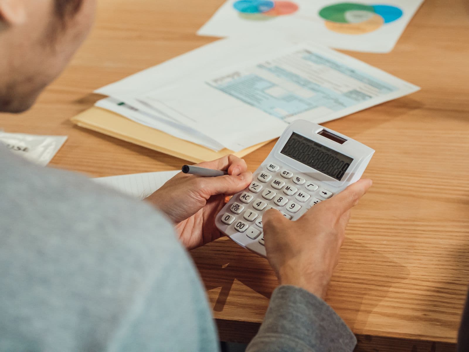 Calculator and paperwork used to compare borrowing costs