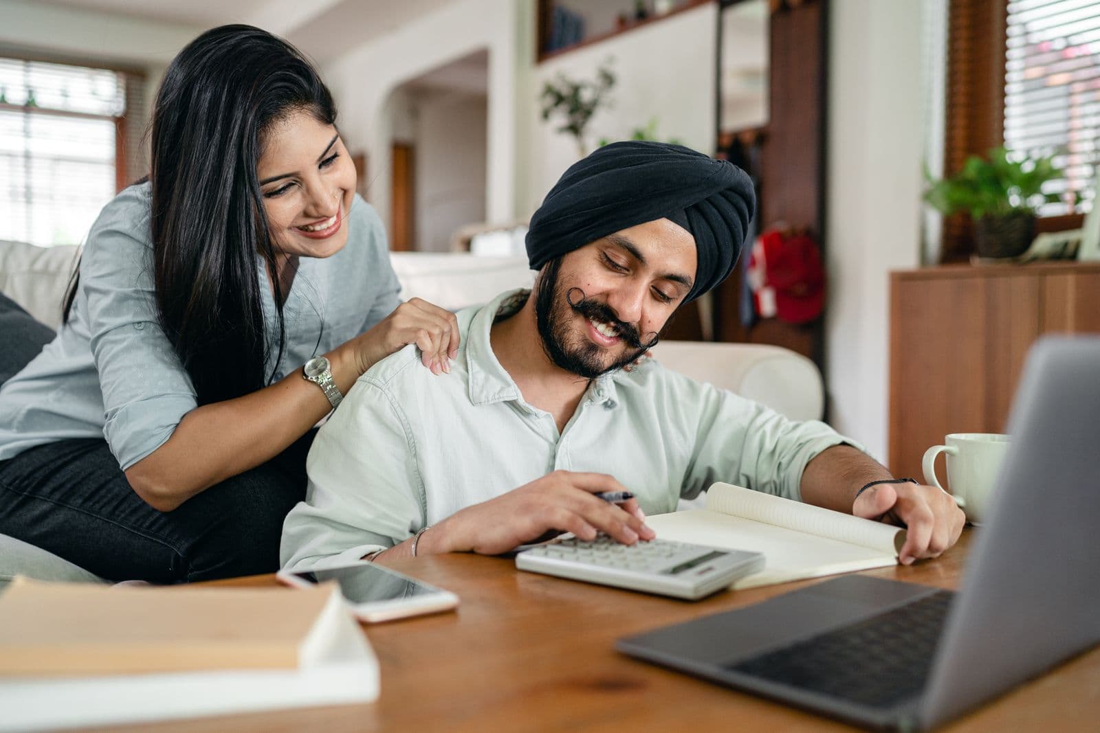 A couple smiling while reviewing paperwork